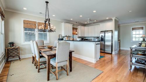 a kitchen with a wooden table and a dining room at Cooper House home by Peace Vacations in Georgetown
