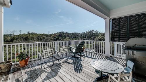 a balcony with a table and chairs on a deck at Cooper House home by Peace Vacations in Georgetown