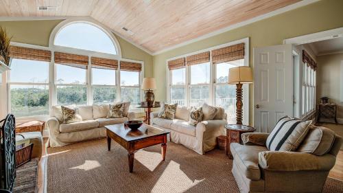 a living room with two couches and a table at Cooper House home by Peace Vacations in Georgetown