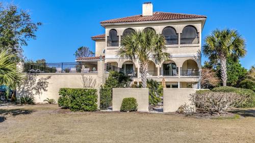 a large house with palm trees in front of it at Mull Cottage home by Peace Vacations in Georgetown