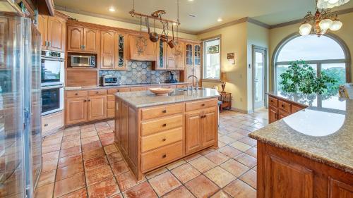 a large kitchen with wooden cabinets and a large island at Mull Cottage home by Peace Vacations in Georgetown