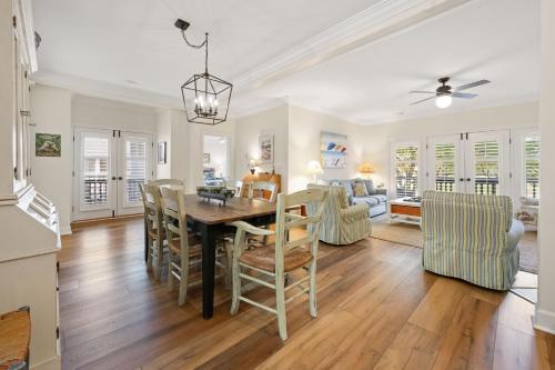 a dining room and living room with a table and chairs at Caddyshack home by Peace Vacations in Georgetown