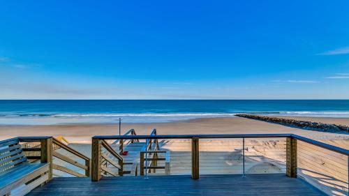 a wooden staircase leading to a beach with the ocean at Magnolia in Pawleys Island home by Peace Vacations in Pawleys Island