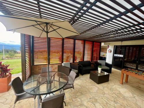 a living room with a glass table and a couch at LUZ DE LUNA mesa de los santos house in Los Santos