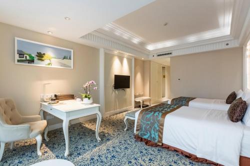 a hotel room with a bed and a desk at Xinhua Media Hotel in Nanjing