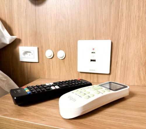 a remote control and a box on a table at Hotel São José in São José