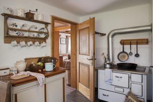 a kitchen with a sink and a stove at Schwadenguetl in Gosau