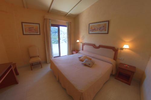 Postel nebo postele na pokoji v ubytování Hotel Avenida
