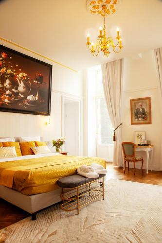 a bedroom with a large bed and a chandelier at Chateau Morreau in Péruwelz