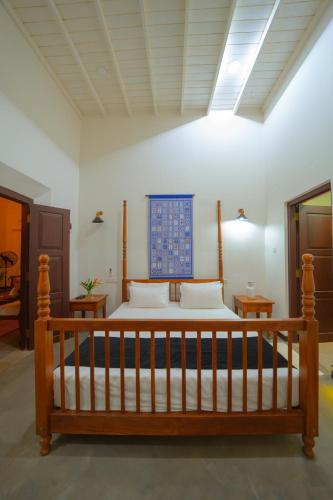 a bedroom with a large bed in a room at Idda Boutique Villa - Four Bedroom Luxury Villa with Private Pool Near the Beach in Ahangama