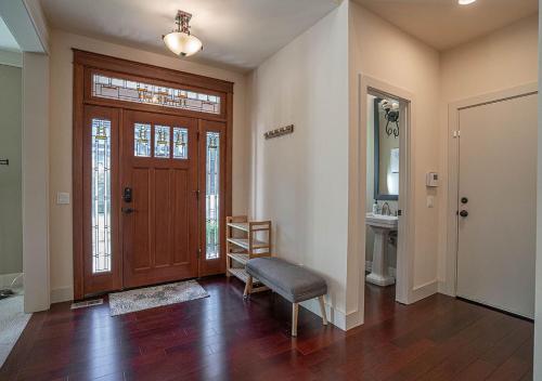 a living room with a wooden door and a chair at Kirkland's Expansive Custom-Built Family Haven Near Juanita in Kirkland