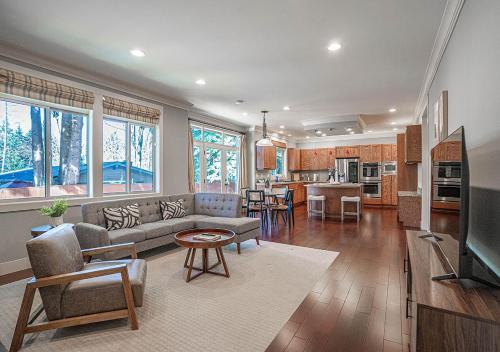 a living room with a couch and a table at Kirkland's Expansive Custom-Built Family Haven Near Juanita in Kirkland