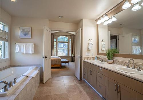 a large bathroom with two sinks and a tub at Kirkland's Expansive Custom-Built Family Haven Near Juanita in Kirkland