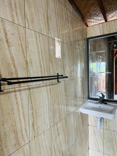 a bathroom with a sink and a window at Kintamani Cabins in Kintamani