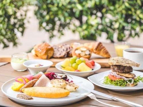 a wooden table with plates of food on it at Hakone Retreat F&ouml;re in Hakone