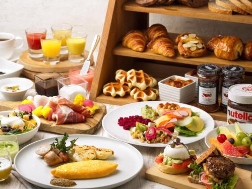 a table topped with plates of food and pastries at Hakone Retreat F&ouml;re in Hakone