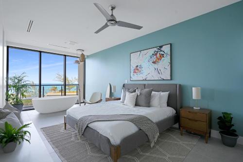 a bedroom with a large bed and a bathtub at VIDA Cayman Luxury Boutique Eco Hotel in West Bay