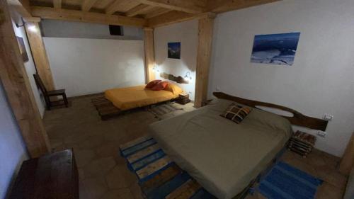 a bedroom with two beds in a room at Agriturismo La Caraffara sull' Etna in Puntalazzo