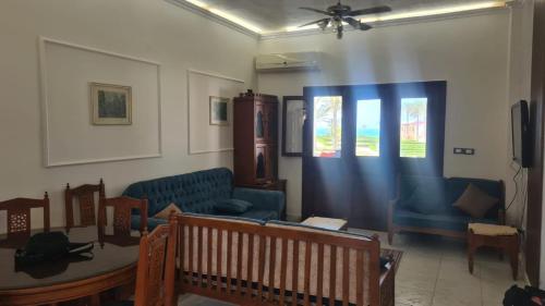 a living room with a blue couch and a table at قريه سما العريش in Arish