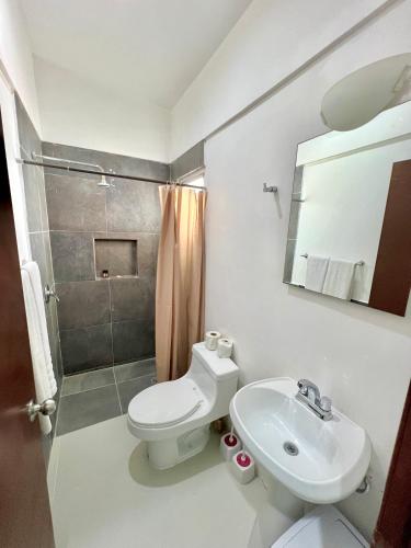 a bathroom with a toilet and a sink and a shower at Marina del Sol 402 Vista al Mar in Mazatlán
