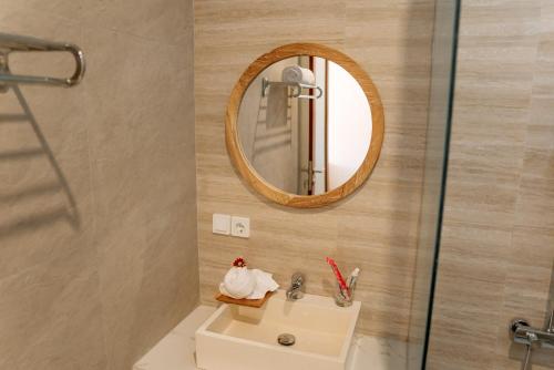 a bathroom with a sink and a mirror at Bali Made Escape in Gianyar