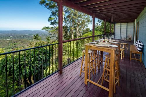 a wooden deck with a table and chairs on it at Montville Retreat With Hinterland & Coastal Views in Montville