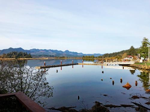 a lake with a dock and mountains in the background at Wheeler on the Bay Lodge and Marina in Wheeler