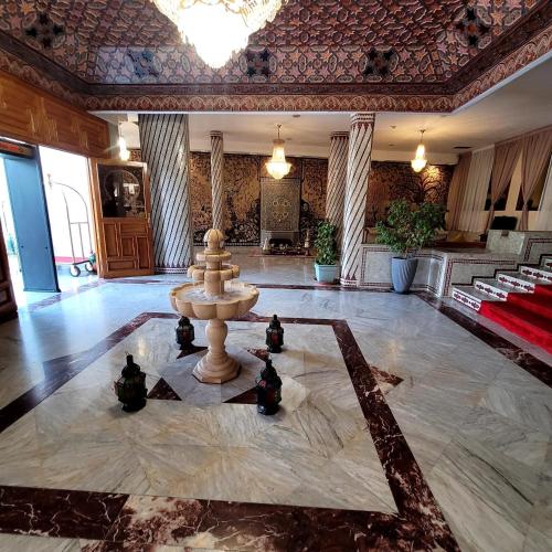 a large lobby with a fountain in the middle of a room at Menzeh Zalagh 2Boutique Hôtel & Sky in Fès