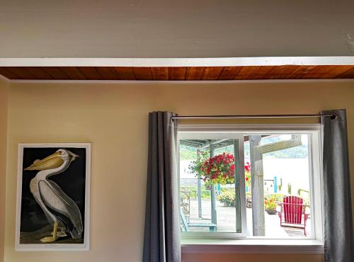 a painting of a bird on the wall next to a window at Wheeler on the Bay Lodge and Marina in Wheeler