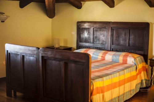a bedroom with a bed and wooden cabinets at Azienda Agrituristica Alcastlè in Montabone