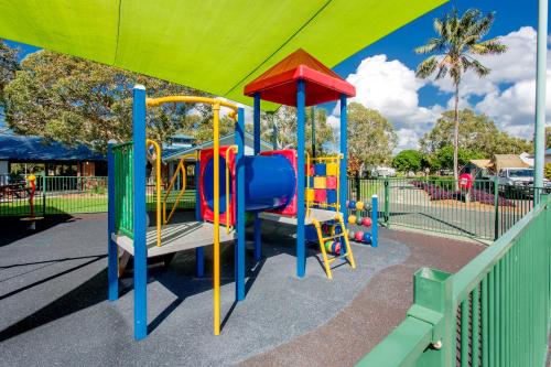 a playground with a slide in a park at BIG4 Park Beach Holiday Park in Coffs Harbour