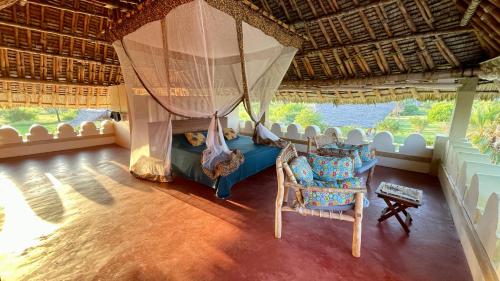a room with a swing and two chairs in it at Pangani Cliffs Lodge in Pangani