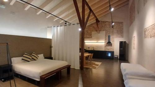 a bedroom with a bed and a table in a room at Amazing suite by the fair in Valencia