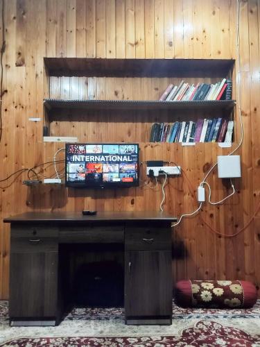 a wooden wall with a desk in a room at The Bilt farmhouse in Srinagar