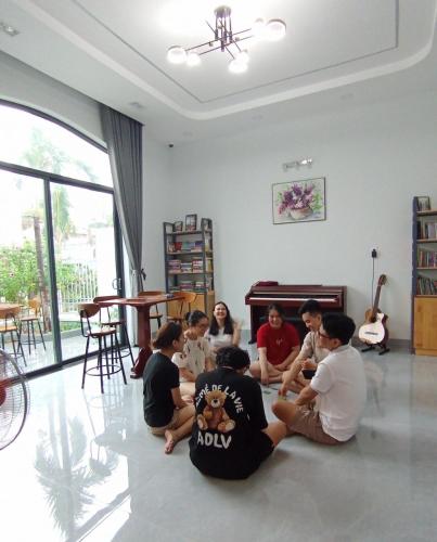 a group of people sitting on the floor in a room at Windy Homestay Phan Thiết in Phan Thiet
