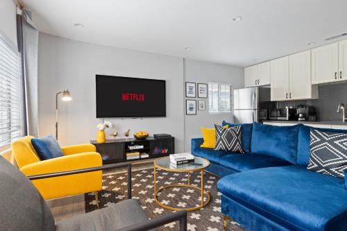 a living room with a blue couch and yellow chairs at Luxury Oasis in Culver City! Free parking and Jacuzzi in Los Angeles