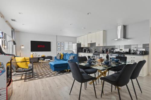 a living room with a table and a blue couch at Luxury Oasis in Culver City! Free parking and Jacuzzi in Los Angeles