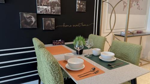 a dining room table with chairs and a table with at The Ress - The Axon Bukit Bintang Residence in Kuala Lumpur
