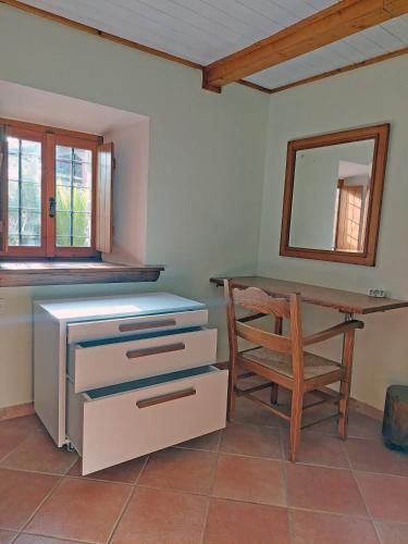 a room with a desk and a chair and a mirror at The Cocoon and olives Hut in Koropi