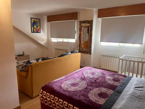a small bedroom with a bed and a staircase at Tomillaron House in Las Rozas de Madrid