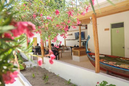 a group of people sitting in a room with flowers at Shifa Lodge Maldives in Feridhoo