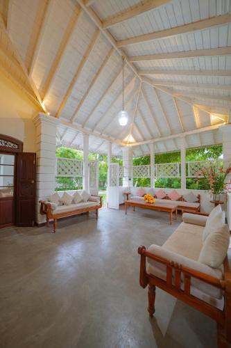 a large living room with couches and tables at Idda Boutique Villa - Four Bedroom Luxury Villa with Private Pool Near the Beach in Ahangama