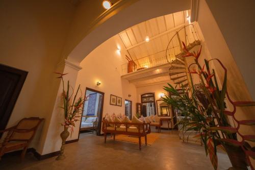 a living room with chairs and tables and plants at Idda Boutique Villa - Four Bedroom Luxury Villa with Private Pool Near the Beach in Ahangama