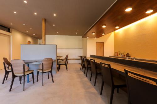 a dining room with a long table and chairs at Hotel 4CROWNS-PREMIERE シルバープラン in Katsuyama
