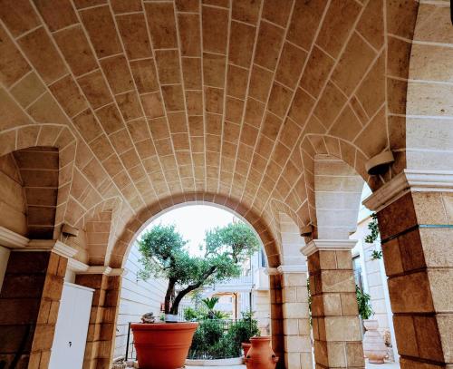 an entrance to a building with a stone ceiling at UNICO Albatres Palace Salento by Life Resorts in San Vito dei Normanni