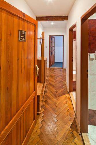 a hallway with wooden walls and wooden floors at Pension Fontána Svitavy in Svitavy