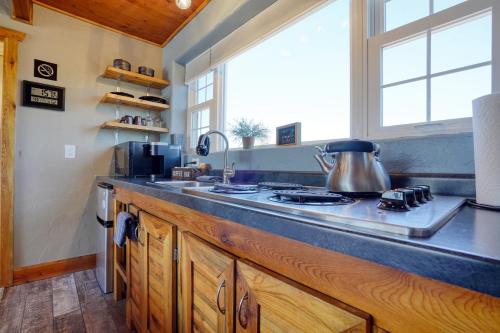 a kitchen with a counter with a stove and a window at Sunrise Cabin at Highland Meadows in Hot Springs