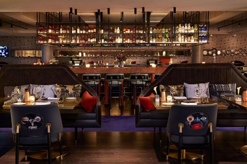 a restaurant with two tables and a bar at QT Melbourne in Melbourne