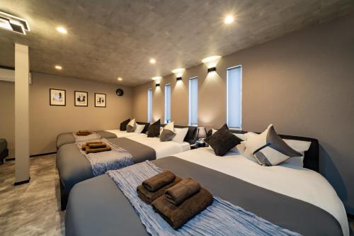 a room with four beds with pillows on them at 91, Honancho A, Entire house for rent, 方南町A in Tokyo