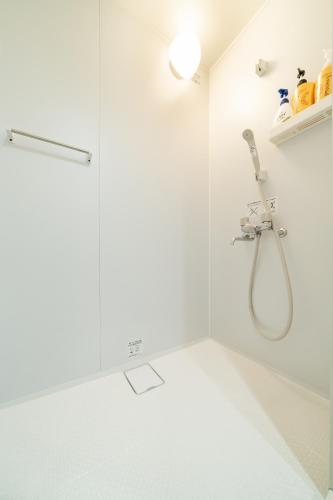 a white bathroom with a shower and a tub at 91, Honancho A, Entire house for rent, 方南町A in Tokyo